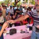 Narendra Nayak doing a card trick with a young volunteer