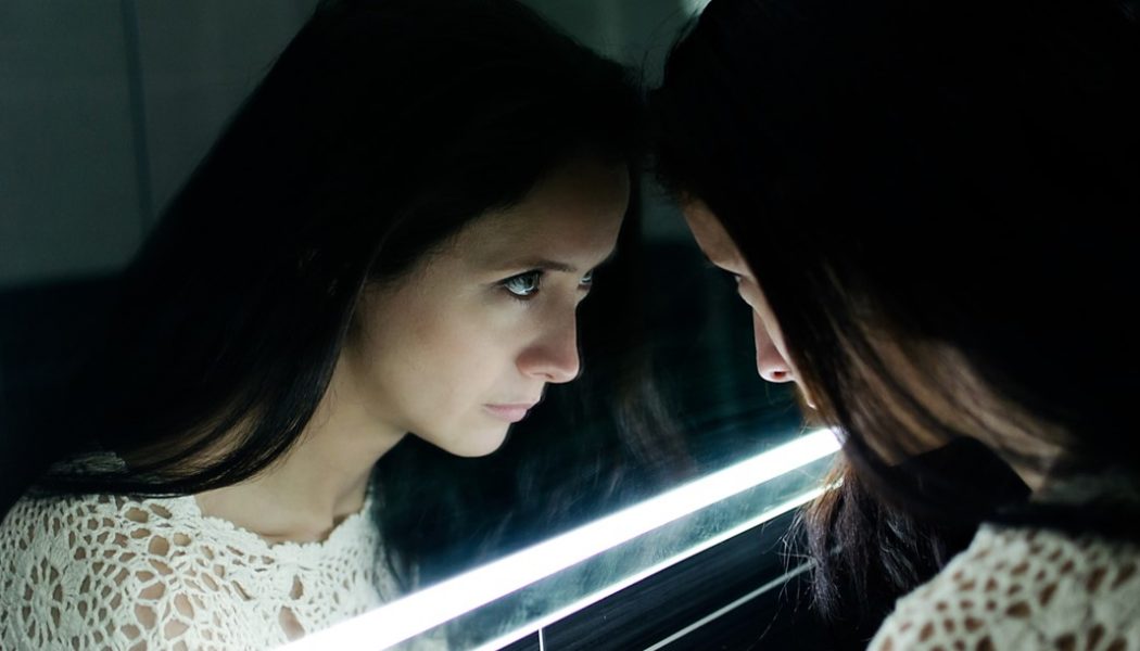 Woman looking in mirror